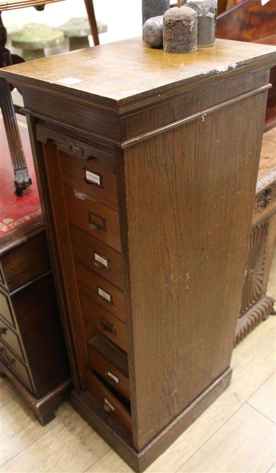 An oak tambour fronted chest containing watch parts H.116cm